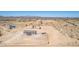 Remote home in arid landscape featuring generous land with outbuildings, perfect for privacy at 52680 W Meadow Green Rd, Maricopa, AZ 85139
