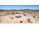 Aerial view of rural home featuring desert landscape and clear blue sky at 52680 W Meadow Green Rd, Maricopa, AZ 85139