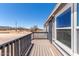 Back porch with gray railing and views of the surrounding desert landscape at 52680 W Meadow Green Rd, Maricopa, AZ 85139