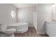 Clean bathroom features a soaking tub, walk in shower, and modern white vanity at 52680 W Meadow Green Rd, Maricopa, AZ 85139