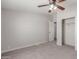 Bright bedroom featuring neutral walls, carpet flooring, a ceiling fan, and an adjoining room at 52680 W Meadow Green Rd, Maricopa, AZ 85139