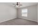 Bright bedroom featuring neutral walls, carpet flooring, and a ceiling fan at 52680 W Meadow Green Rd, Maricopa, AZ 85139