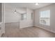 Bright dining room with wood-look floors and large windows at 52680 W Meadow Green Rd, Maricopa, AZ 85139