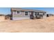 Charming single-story home with a gray exterior and inviting front porch at 52680 W Meadow Green Rd, Maricopa, AZ 85139