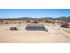Exterior elevation of desert home showcasing modern siding and desert landscape at 52680 W Meadow Green Rd, Maricopa, AZ 85139