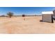 Expansive dirt lot featuring a utility shed and potential for landscaping or development at 52680 W Meadow Green Rd, Maricopa, AZ 85139