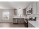 Charming kitchen featuring stainless steel appliances, gray cabinetry, and quartz countertops at 52680 W Meadow Green Rd, Maricopa, AZ 85139