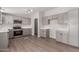 Modern kitchen with stainless steel appliances and gray cabinets at 52680 W Meadow Green Rd, Maricopa, AZ 85139