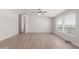 Spacious living room with wood-look floors and lots of natural light at 52680 W Meadow Green Rd, Maricopa, AZ 85139