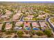 An aerial view showing a home with a pool and spa in a well-maintained community with mountain views at 5428 E Windstone Trl, Cave Creek, AZ 85331