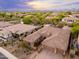 Desert neighborhood featuring tan homes with tile roofs, desert landscaping, and mountain views in the distance at 5428 E Windstone Trl, Cave Creek, AZ 85331