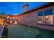 Beautiful backyard features a putting green and a covered patio with string lights, perfect for outdoor enjoyment at 5428 E Windstone Trl, Cave Creek, AZ 85331