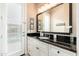 Charming bathroom features a black granite countertop and white cabinets plus a large mirror at 5428 E Windstone Trl, Cave Creek, AZ 85331
