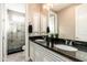 Bathroom features a double vanity with granite countertop and glass enclosed shower with black tile accents at 5428 E Windstone Trl, Cave Creek, AZ 85331