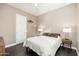 Light filled bedroom with wood floors, neutral walls, white trim, and bedside tables with lamps at 5428 E Windstone Trl, Cave Creek, AZ 85331