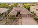 Inviting single-story home with a three-car garage, desert landscaping, and tile roof in a gated community at 5428 E Windstone Trl, Cave Creek, AZ 85331