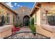 Home's front entrance features a brick walkway, stone facade, and gated courtyard with seating at 5428 E Windstone Trl, Cave Creek, AZ 85331