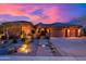 Exterior of charming home featuring lush landscaping and a three car garage at sunset at 5428 E Windstone Trl, Cave Creek, AZ 85331