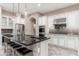 Modern kitchen with a black granite island, stainless steel appliances, and white cabinets at 5428 E Windstone Trl, Cave Creek, AZ 85331