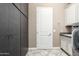 Functional laundry room with storage cabinets, utility sink, granite counters and access to storage at 5428 E Windstone Trl, Cave Creek, AZ 85331