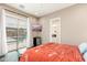 Bedroom with wood floors, access to the patio and pool, mounted TV and adjoining bathroom at 5428 E Windstone Trl, Cave Creek, AZ 85331