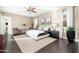 Spacious main bedroom with a ceiling fan, dark hardwood floors, and an abundance of natural light at 5428 E Windstone Trl, Cave Creek, AZ 85331