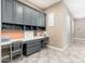 Bright office with gray cabinets, desk, corkboard, shelving, and natural light from the shuttered windows at 5428 E Windstone Trl, Cave Creek, AZ 85331