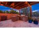 This outdoor kitchen features a built in grill, fridge and countertop area and plenty of storage for cooking supplies at 5428 E Windstone Trl, Cave Creek, AZ 85331