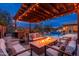 Enjoy a built-in fire pit, seating, and an outdoor kitchen area with a built-in grill, sink, and prep space at 5428 E Windstone Trl, Cave Creek, AZ 85331