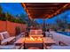 This home features a built-in fire pit, seating, and an outdoor kitchen area with a built-in grill, sink, and prep space at 5428 E Windstone Trl, Cave Creek, AZ 85331