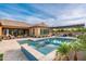 This backyard showcases a beautiful pool, a covered patio, and ample space for outdoor seating and entertaining at 5428 E Windstone Trl, Cave Creek, AZ 85331