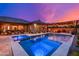 Inviting backyard pool and spa with outdoor seating, a fire pit, and a pergola at dusk at 5428 E Windstone Trl, Cave Creek, AZ 85331