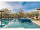 Backyard features a sparkling pool and a tranquil spa, surrounded by desert landscaping and a lounge chair at 5428 E Windstone Trl, Cave Creek, AZ 85331