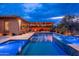 Enjoy this pool with a connecting spa and an outdoor kitchen area with a built-in grill, sink, and prep space at 5428 E Windstone Trl, Cave Creek, AZ 85331
