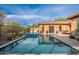 Sparkling blue pool with water feature, desert landscaping, and sun loungers for relaxation at 5428 E Windstone Trl, Cave Creek, AZ 85331