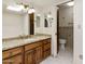 Bathroom featuring granite counters, wood cabinets, and tile flooring at 5622 N Palacio Way, Phoenix, AZ 85014