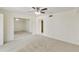Spacious carpeted bedroom featuring a full mirrored wall and ceiling fan at 5622 N Palacio Way, Phoenix, AZ 85014