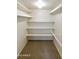 Walk-in closet with neutral colored carpet and organized shelving at 5622 N Palacio Way, Phoenix, AZ 85014