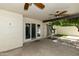 Inviting covered patio with ceiling fans and access to the yard via sliding glass doors at 5622 N Palacio Way, Phoenix, AZ 85014