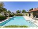 Sparkling pool with lounge chairs surrounded by mature landscaping and tile roof building at 5622 N Palacio Way, Phoenix, AZ 85014