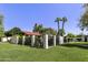 Landscaped yard with mature trees, lush green lawn, and privacy fencing at 5622 N Palacio Way, Phoenix, AZ 85014