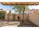 Private backyard features a mature tree, a cactus, and a covered patio area, perfect for relaxing at 5637 N 78Th Way, Scottsdale, AZ 85250