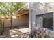 Well-maintained backyard with lush flowering bushes, a cacti, and a covered patio at 5637 N 78Th Way, Scottsdale, AZ 85250