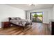 Bright bedroom with wood floors and sliding doors to outdoor space at 5637 N 78Th Way, Scottsdale, AZ 85250
