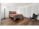 Inviting bedroom with hardwood floors, stylish lighting, and a large closet at 5637 N 78Th Way, Scottsdale, AZ 85250