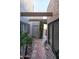 Inviting front entrance with tiled pathway, lush plants, and decorative beams enhancing curb appeal at 5637 N 78Th Way, Scottsdale, AZ 85250