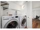 Functional laundry room with modern washer and dryer, storage, and convenient access to the hallway at 5637 N 78Th Way, Scottsdale, AZ 85250