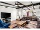 Large living area featuring a beamed ceiling, a plush couch, and seamless open floorplan at 5637 N 78Th Way, Scottsdale, AZ 85250