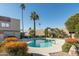 Community pool with lush landscaping, mature trees, and clear blue water creating an oasis at 5637 N 78Th Way, Scottsdale, AZ 85250