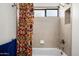 Bathtub with neutral tile surround and decorative curtain and shower head at 5637 N 78Th Way, Scottsdale, AZ 85250
